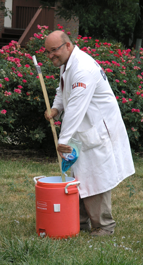 Jesse sneaks more liquid detergent into the container.