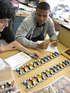 Two students work on Lego kit.