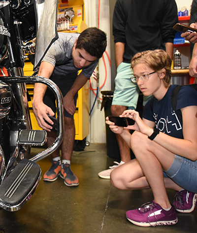 Students check out a Harley Davidson motorcycle.