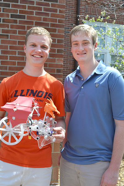 Two of Liebenberg's spring 2018 ME370 students, Evan Wahl and his teammate Tom Penicook, show off their walker, Todd the Dragon during the final event of the spring 2018 ME370 automaton competition.