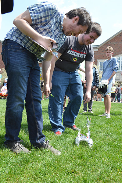 An ME370 student performs an intervention on his walker, which kept falling over due to the terrain.