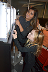 Mashruba Haque shows a young MakerGirl visitor the 3D printers.