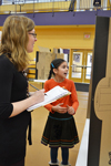 Psychology Professor Kara Federmeier evaluates an NGS student's presentation during the fair.