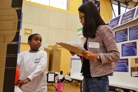 An NGS student presents his research project to Yi Lou, an Illinois Ph.D. student in Natural Resourcs and Environmental Science.