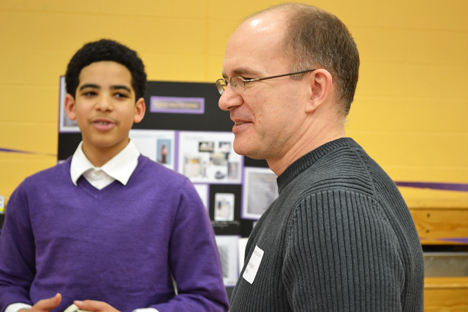 An NGS student presents his project to professor Adam Poetzel