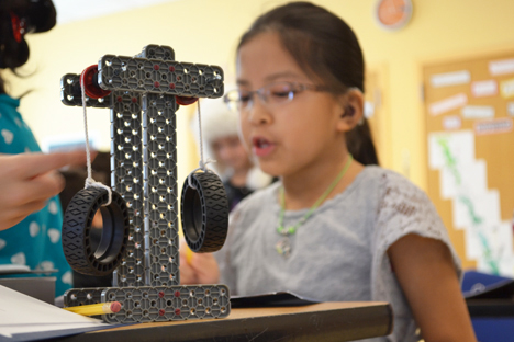 Close up of the design the fourth grader in the background helped build.