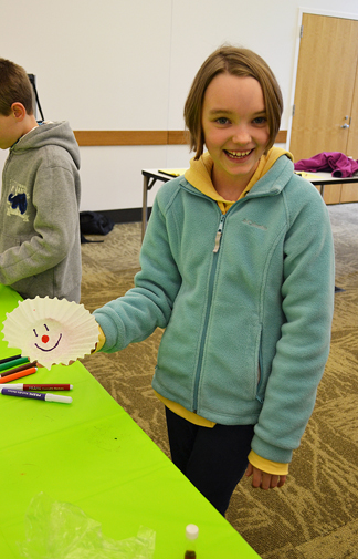 A local 10-year-old displays the picture she drew to see the capillary action property in action. 