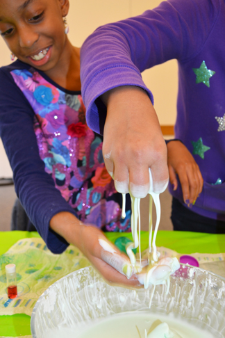 Two NGS students demonstrate the part solid/part liquid properties of oobleck.