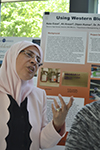 During the recent RET poster session, Azza Ezzat shares with a visitor about her research on receptor differences in cancer cells.