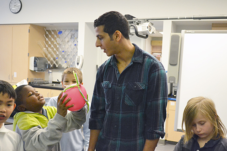An Illinois grad student interacts with a BTW student during a NanoSTRuCT session.