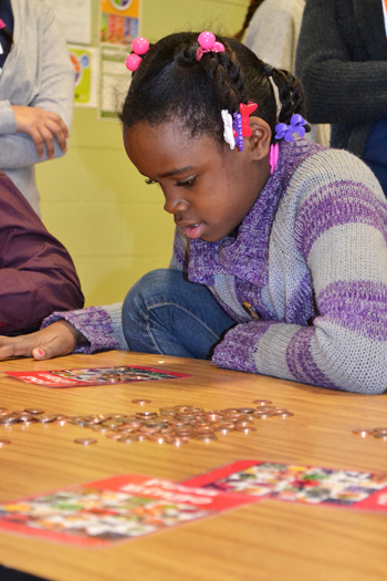 A youngster at Prairie Elementary learns about nutrition while playing bingo.