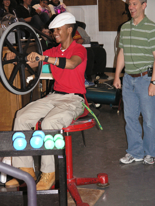 Volunteer experiences the conservation of angular momentum.