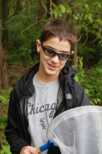 CPS student captures insect at Pollinatarium.