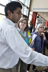 Clockwise from left: CEE grad student Jeevaka Somaratna explains CEE 398 to Ann Horton-Weis and Lizanne DeStefano of I-STEM.