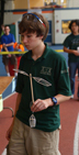 Science Olympiad student demonstrates his exhibit.