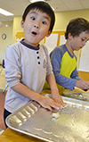 A student at Next Generation School's STEAM Studio uses clay and popsicle sticks to make a shelfstone while learning about speleothem during a unit on caves.