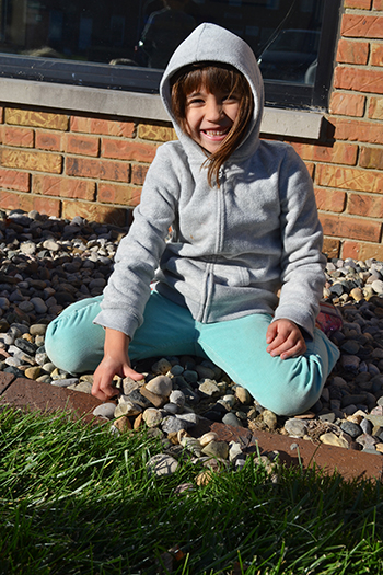 A Zepto group student gathers some rocks which they will later test.