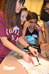 A participant tests the battery she and her teammates made.