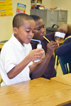 Two brothers blow through straws trying to "levitate" a ping-pong ball in order to observe the Bernoulli principle for themselves.