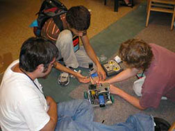 Science Olympiad students working with robot.
