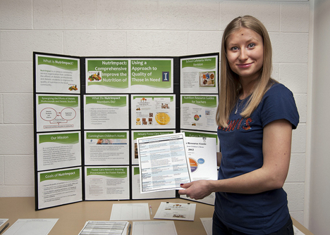 Lisa Shkoda presents NutrImpact posters and materials at the 2013 Public Engagement Symposium.