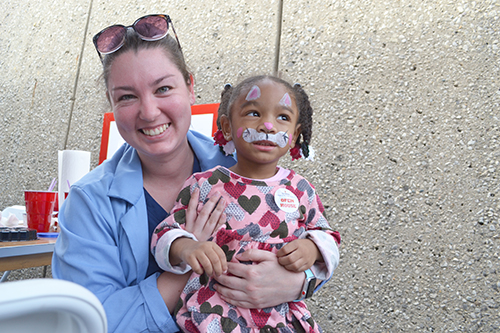     Vet Med student Aiden Tansey and her young friend, face painted as a...bunny?
