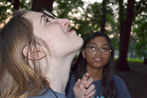 Below: A freshman balances an Oreo cookie on her forehead during a minute-to-win-it game.