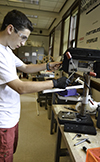 Exploring MechSE camper uses a drill press to make his team's wind turbine