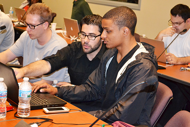 Mobeen Ludin (center) works with a Blue Waters intern during a coding workshop