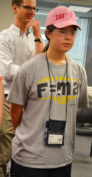 Matt West (left) and a G-BAM camper watch as her fan assembly design is tested.