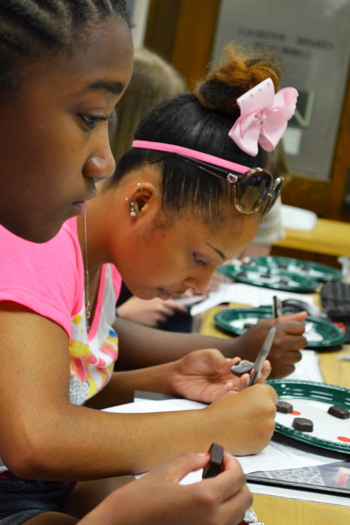 Two GLAM G.A.M.E.S. campers analyze chocolate.