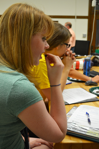 girls in the GLAM G.A.M.E.S. camp participate in a session about bloom on chocolate—which requires tasting some.