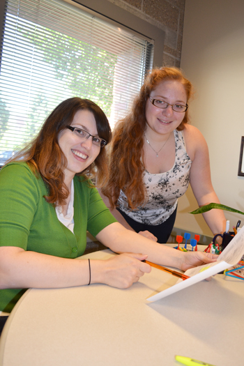  Jenny Amos and Olivia Cangellaris review their camp schedule.