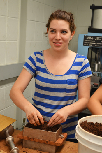 Camper makes a sand mold for the sand casting project.