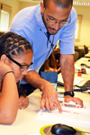 GLEE camp director, Lynford Goddard, instructs a camper during a session on optics.