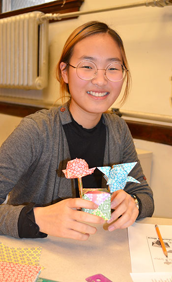 A GEMS participant shows off her origami creations.