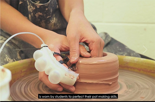 The ceramics teacher wears a sensor while throwing a pot in order to measure the pressure he’s putting on the clay. (<a href=