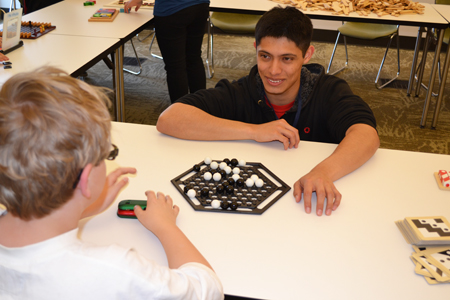 Emmanuel Del Rio, a junior in math at Illinois, plays a math game with a local student.
