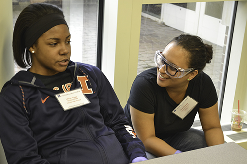 Estrada speaks with Lauryn Cross, an Urbana High School student-athlete, during the I-STEM Camp's MCB Day