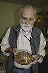 Allen with a replica of the first transistor invented at Bell Laboratories in New Jersey on December 23, 1947.