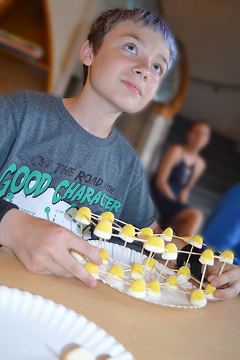 A local child makes a graphite molecule with the candy.