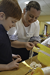 STEAM Studio director Angela Nelson (right) works with a student making a headlamp