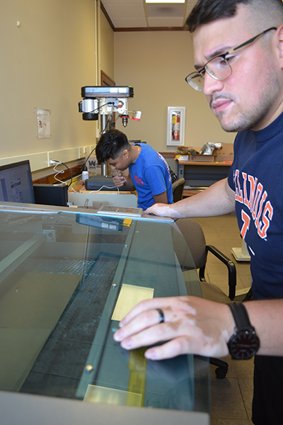 Jesus Zavala and Lorena Escamilla hard at work preparing for ISE's Renaissance WYSE camp