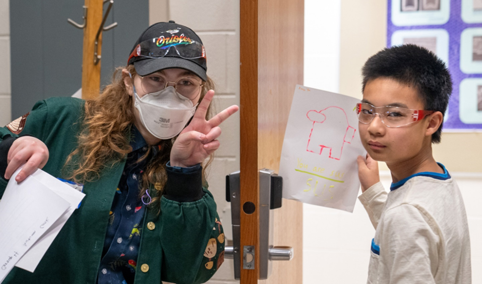 At left, Autumn Cook and a middle school participant show off their creation from the fluorescence activity. (Photo by Heather Coit)