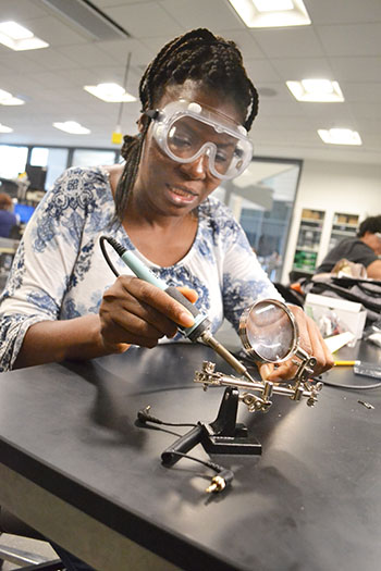 Chicago Vocational Career Academy’s instructional technology teacher, Lillian Perteete, solders the circuit she’s making.