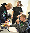 Christing Mehr (center) gives some advice to a couple of students building their egg-drop apparatus.