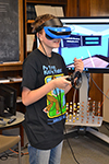 An eighth grader experiences virtual reality during the students' visit to MRL.