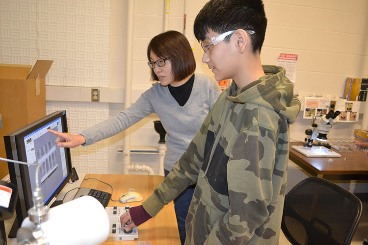 MRL's Jade Wang instructs a Franklin seventh grader about how to use MRL's Scanning Electron Microscope (SEM) during their visit to MRL