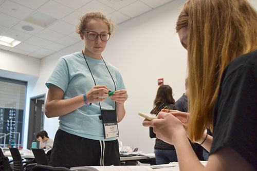 Julian Lipford (left), waits to see if her LED calculator is done correctly. 