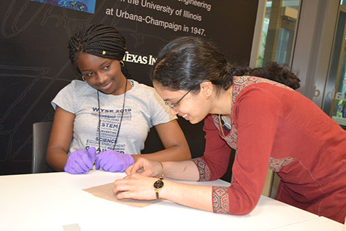 In her fourth summer helping out with GLEE camp was ECE Ph.D. student Aditi Udupa (right) who is helping a camper with her solar cell.